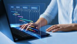 Project manager working on laptop and updating tasks and milest