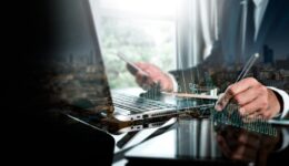 Cost and quality management, corporate strategy, and the idea of project management. A businessperson using a digital tablet to conduct productive business while monitoring quality control growth