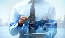 Businessman holding tablet and magnifier