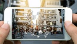 Internet of things (IoT) and digital lifestyle concept . Hand holding smart phone , wifi icons and city view background.