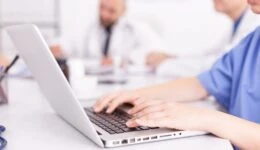 Medical practitioner typing diagnosis