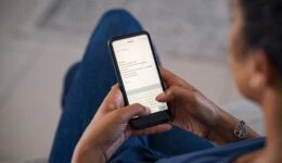 Woman typing email on smartphone