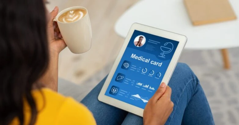 Black lady checking her medical card online, using pad