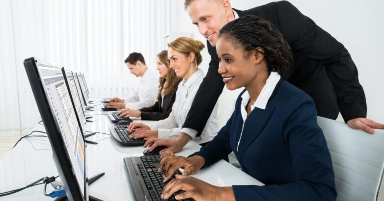Manager Assisting His Staff In Office