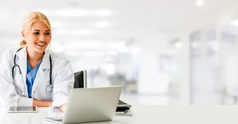 Doctor using laptop computer at the hospital.